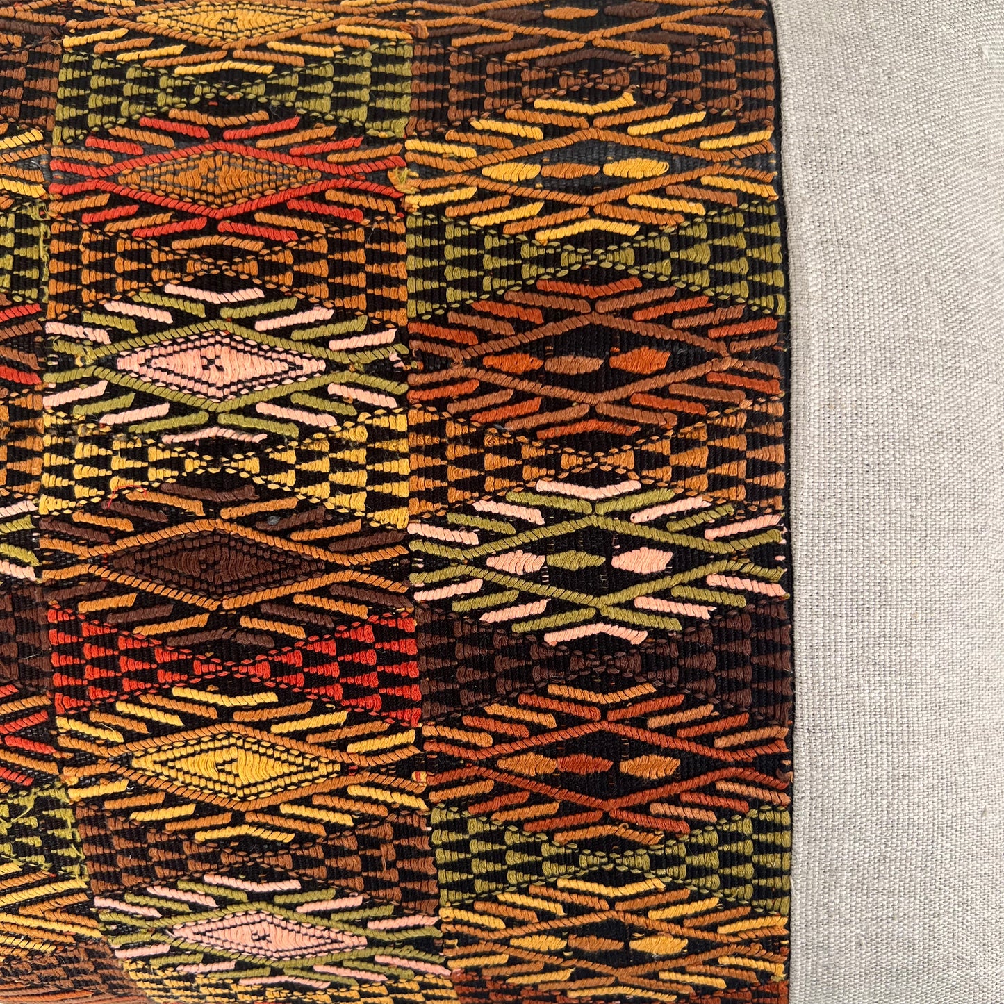 Close up of Brown Accent Huipil and Hemp Pillow on a light gray background - Intertwined: Handmade for Good
