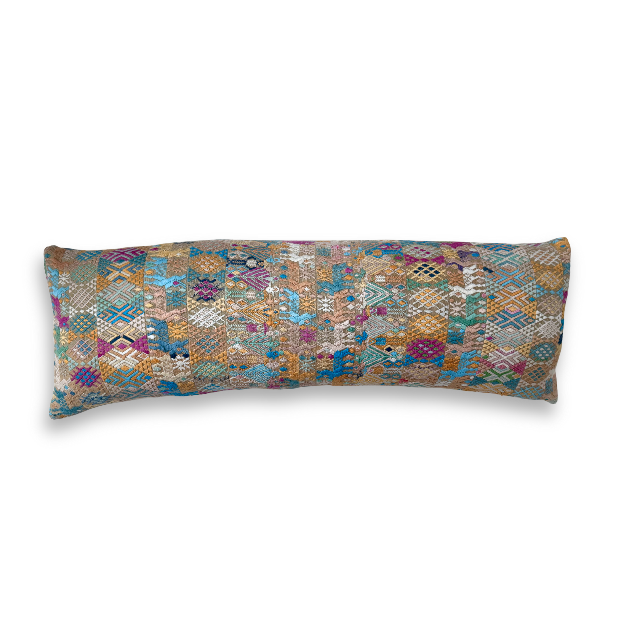 Long, rectangular pillow with a multicolored geometric pattern on a white background