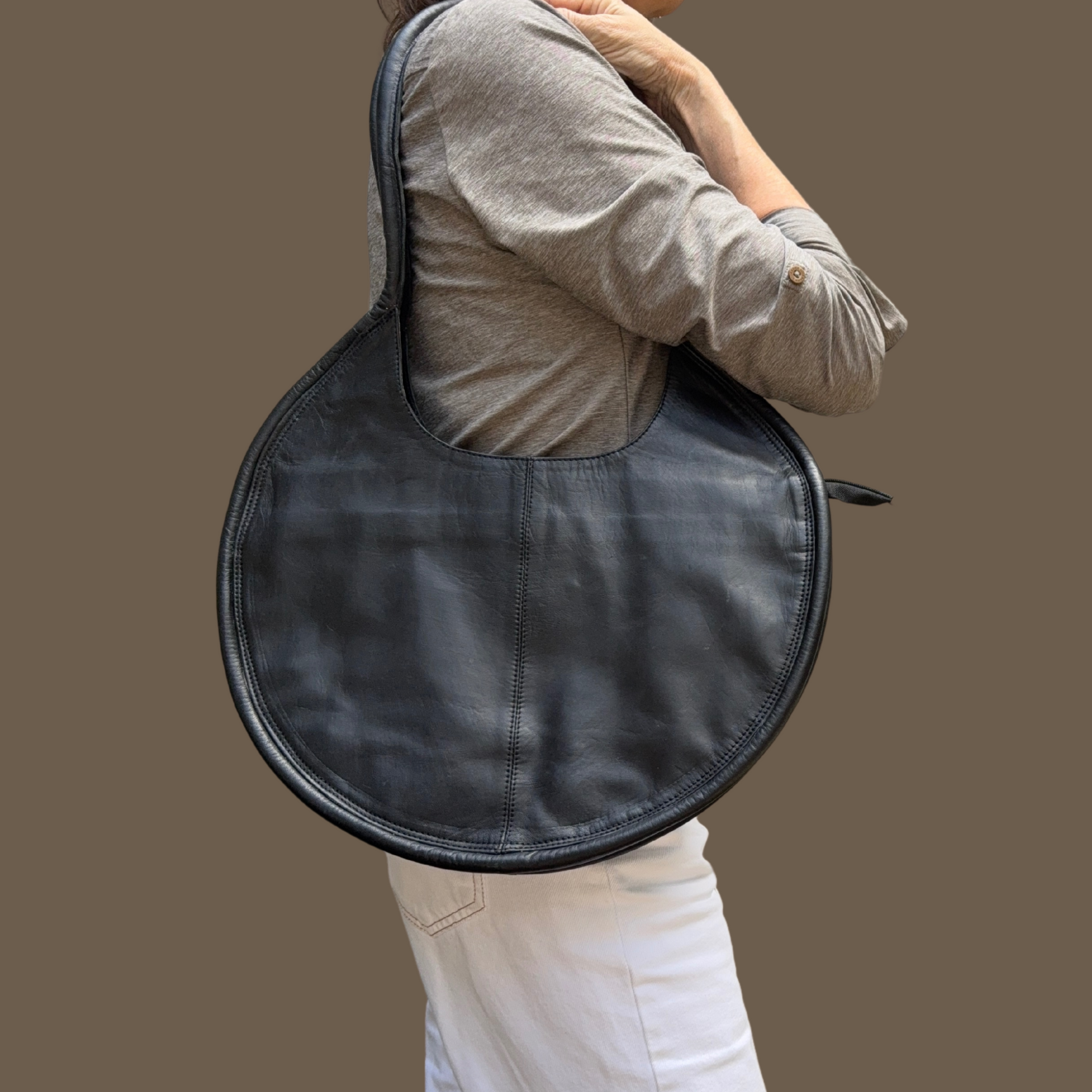 circle backpack leather Kyah Full-Grain Crossbody Bag Handcrafted in Ethiopia exclusive circular shape for a refined look Capacity Dr.Martens x WEDNESDAY Round Backpack