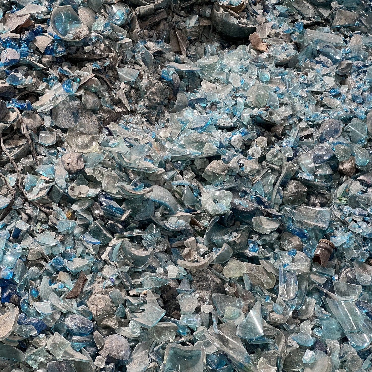 Close-up of crushed glass with blue and clear fragments