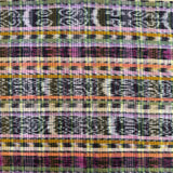 A close-up of a woven textile with horizontal multicolor stripes and geometric patterns in purple, pink, orange, yellow, green, black, and white.