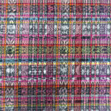 A close-up of a multicolor plaid fabric pattern with pink, purple, orange, blue, green, and gray intersecting stripes and distressed texture.