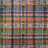 A close-up of a multicolored plaid ikat fabric pattern with vertical wavy stripes in pink, green, blue, yellow, red, and white.