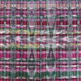 A close-up of a woven textile with an intricate ikat pattern in shades of pink, green, purple, and white.