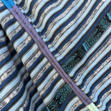 Close-up of fabric with blue, gray, and green striped pattern