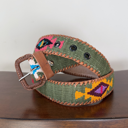 Green belt with colorful fish pattern on a wooden surface