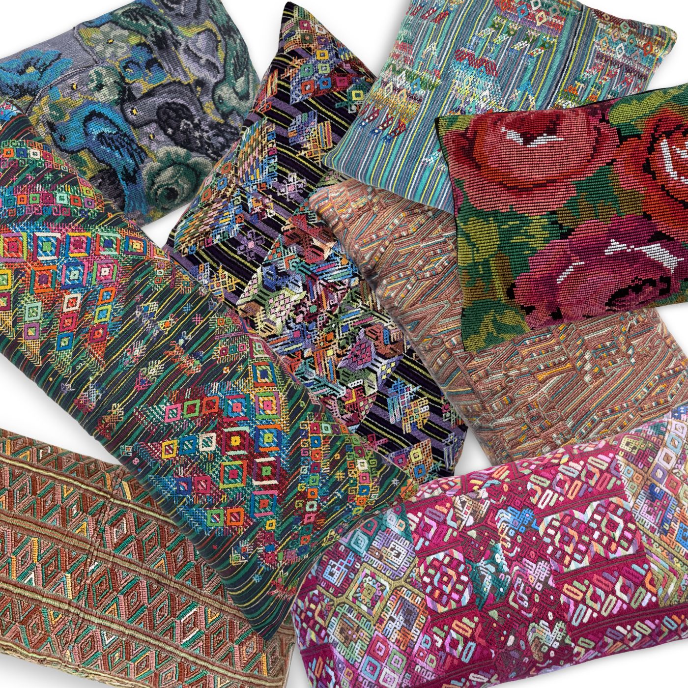 Collection of colorful embroidered huipil pillows with various patterns and designs.