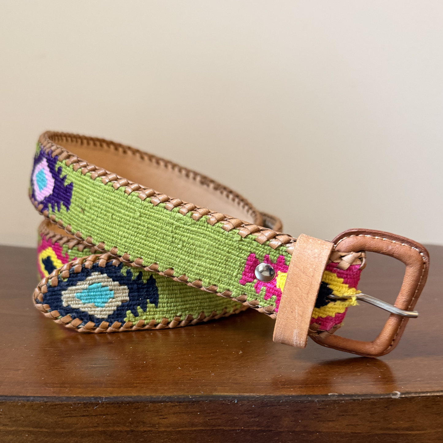 Colorful belt with intricate patterns on a wooden surface