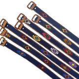 Set of blue belts with colorful patterns and brass buckles on a white background