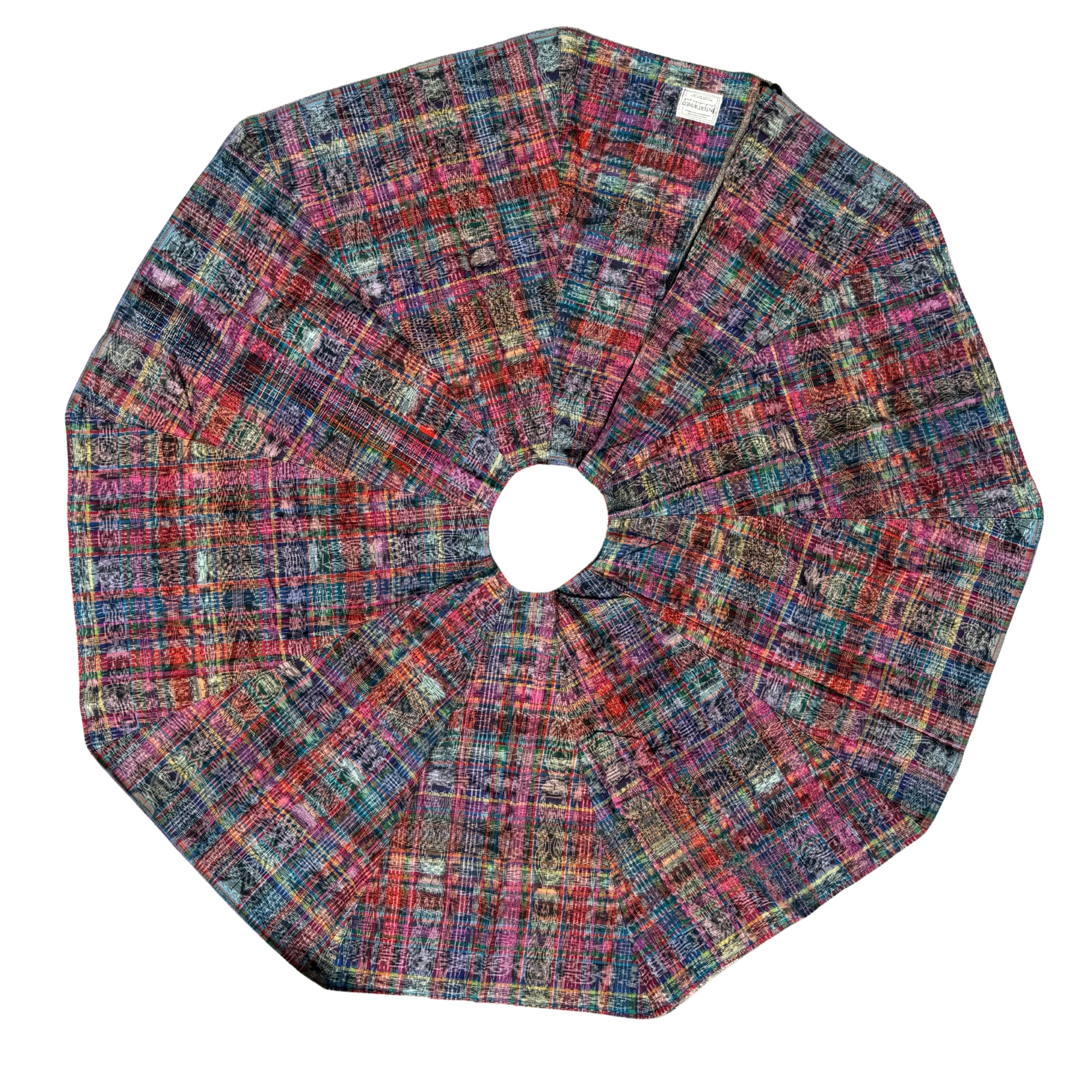 A circular fabric tree skirt with a multicolor plaid and tweed pattern, laid flat on a white background.