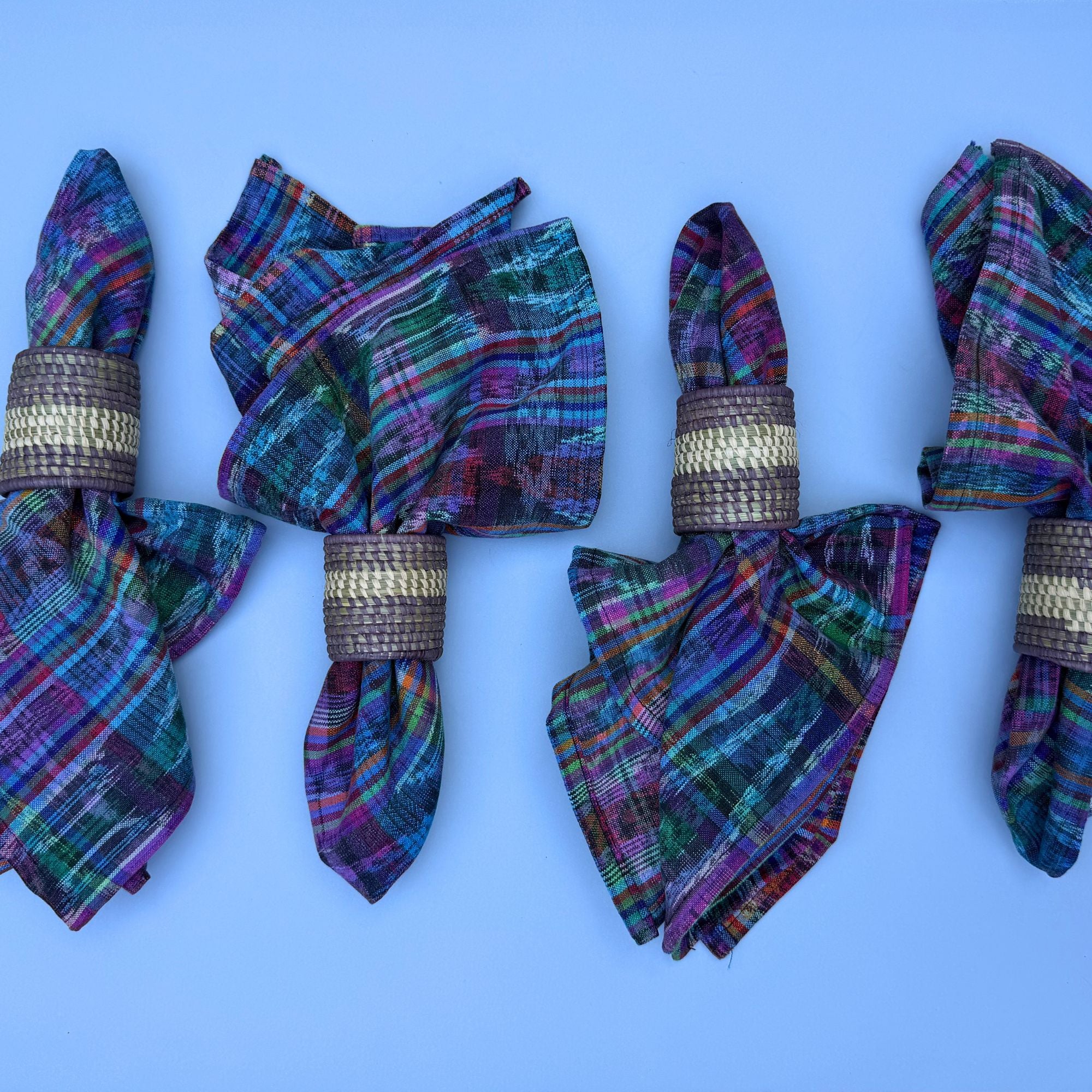 Colorful plaid napkins with gold rings on a blue background