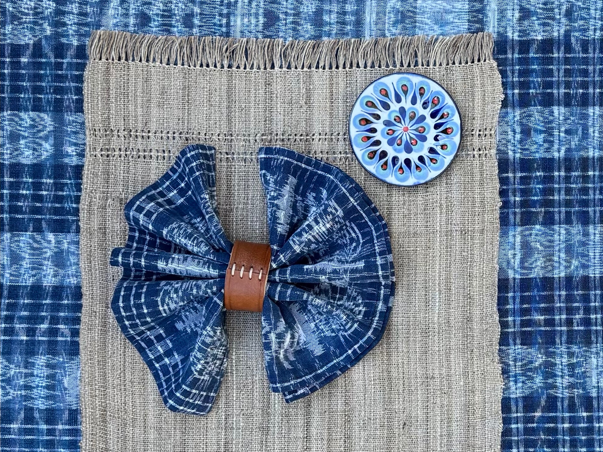 Indigo jaspe napkin in leather napkin ring with indigo jape table runner in background