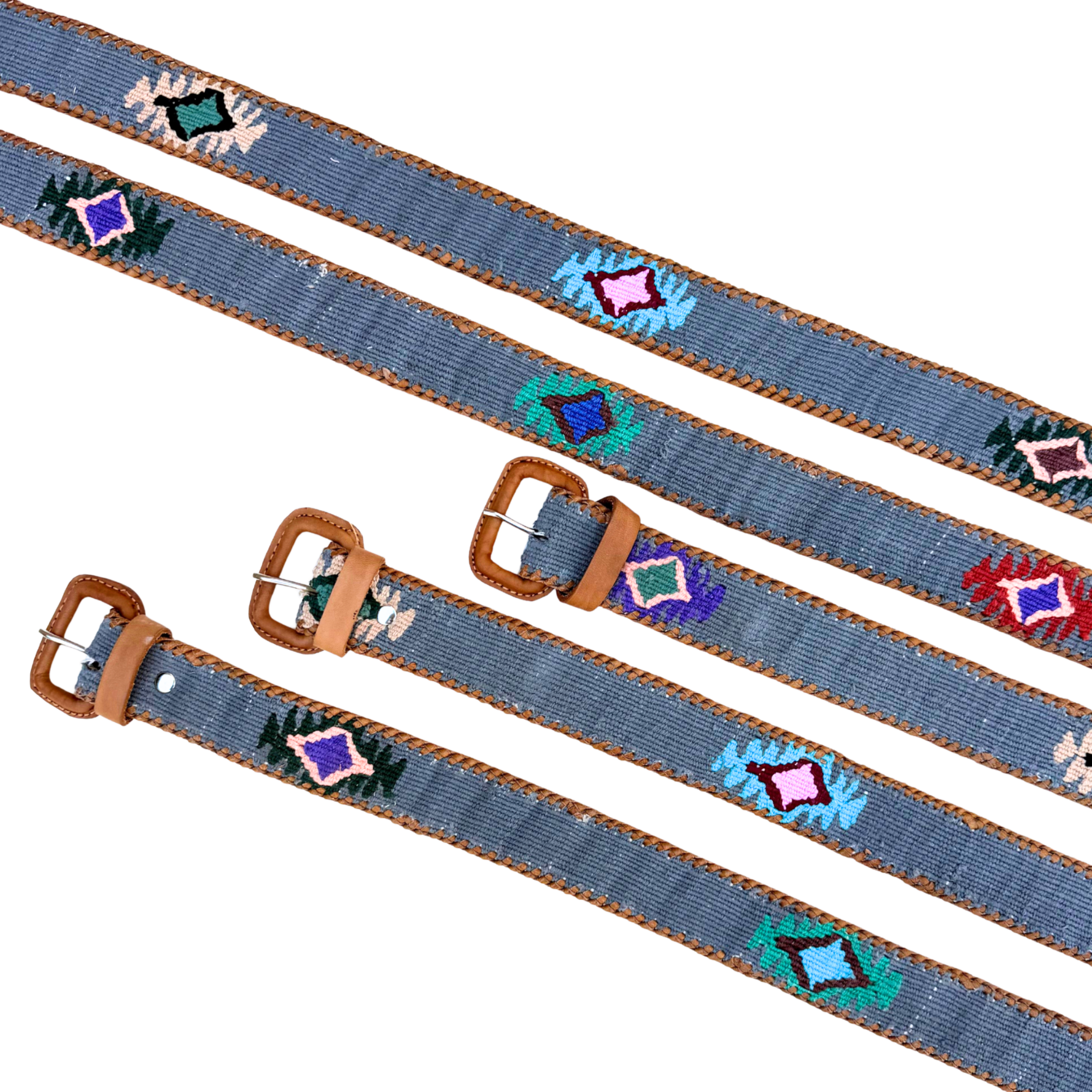 Two blue belts with decorative patterns and brown buckles on a white background