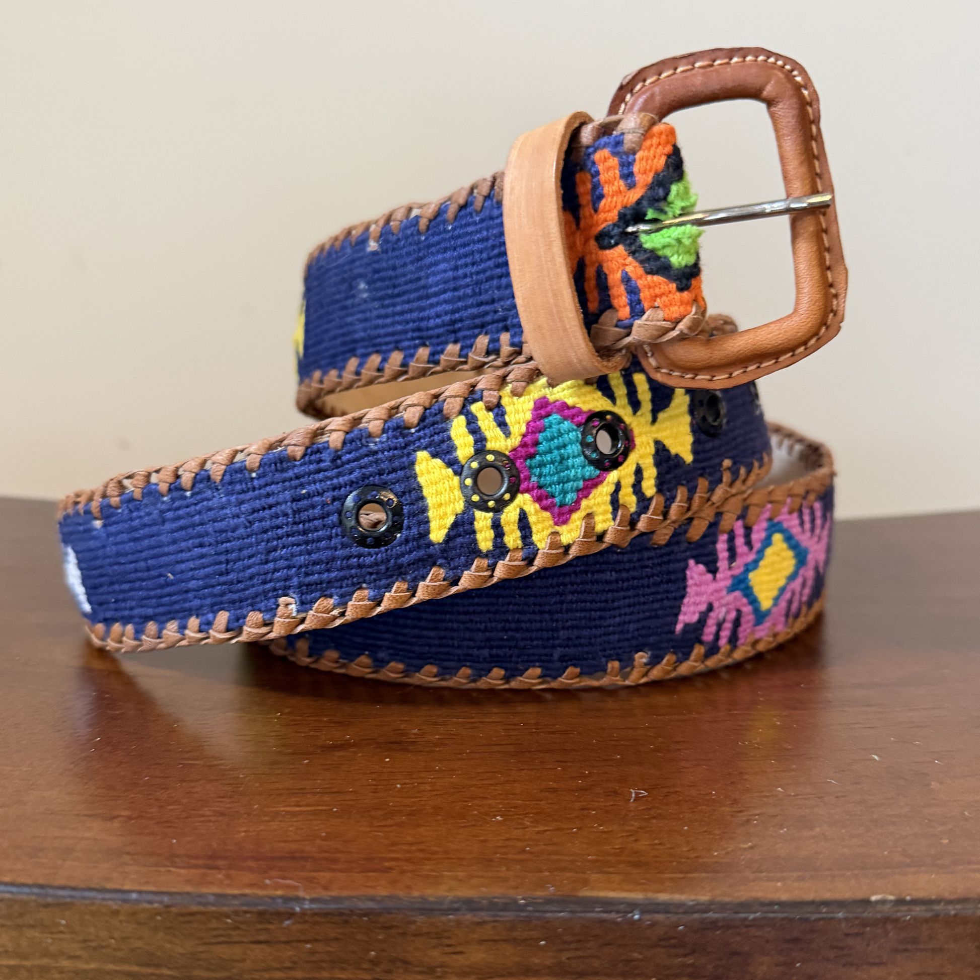 Colorful belt with a pattern on a wooden surface