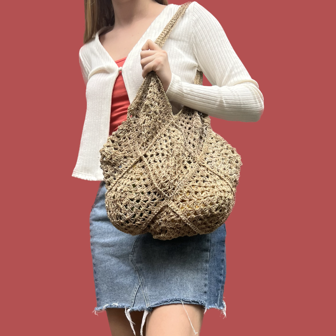 Model with Hemp Crocheted Market Bag over shoulder on a red background - Intertwined: Handmade for Good