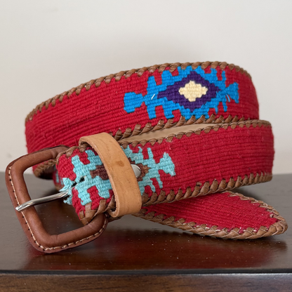 Red belt with blue and brown patterns on a wooden surface