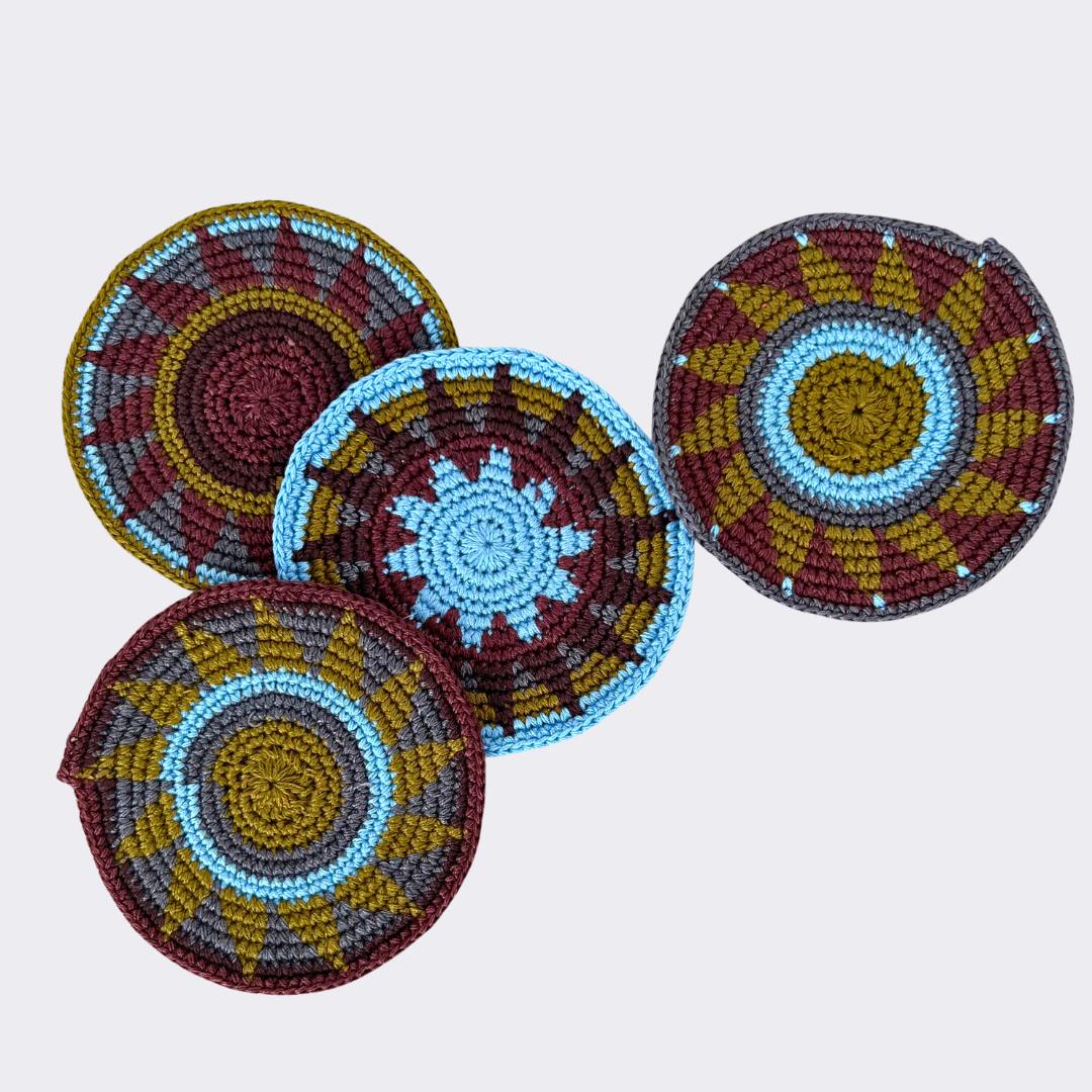 Olive and blue crocheted coasters on a light gray background - Intertwined: Handmade for Good