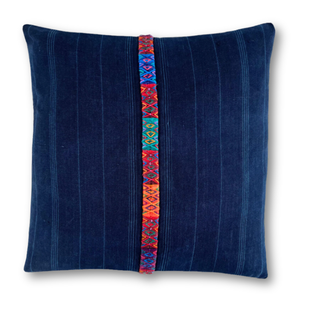 Indigo corte pillow with a multicolor embroidered stripe down middle.