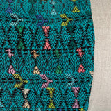 Close up of Green Huipil and Hemp Pillow on a light gray background - Intertwined: Handmade for Good