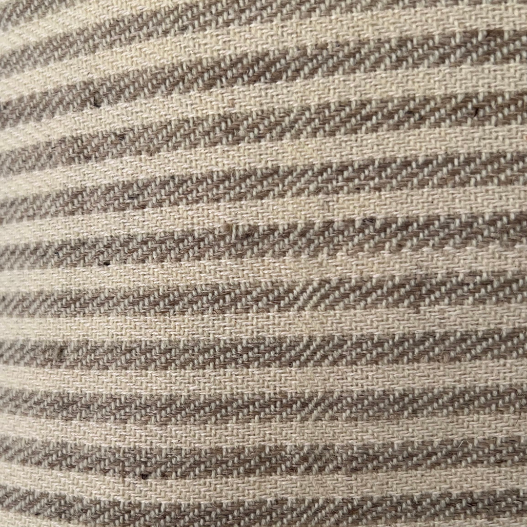 Close up of Light brown striped nettle pillow on white background - Intertwined: Handmade for Good