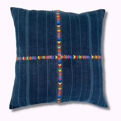 Intertwined's Indigo Corte Pillow with a hand embroidered multicolor cross down middle.