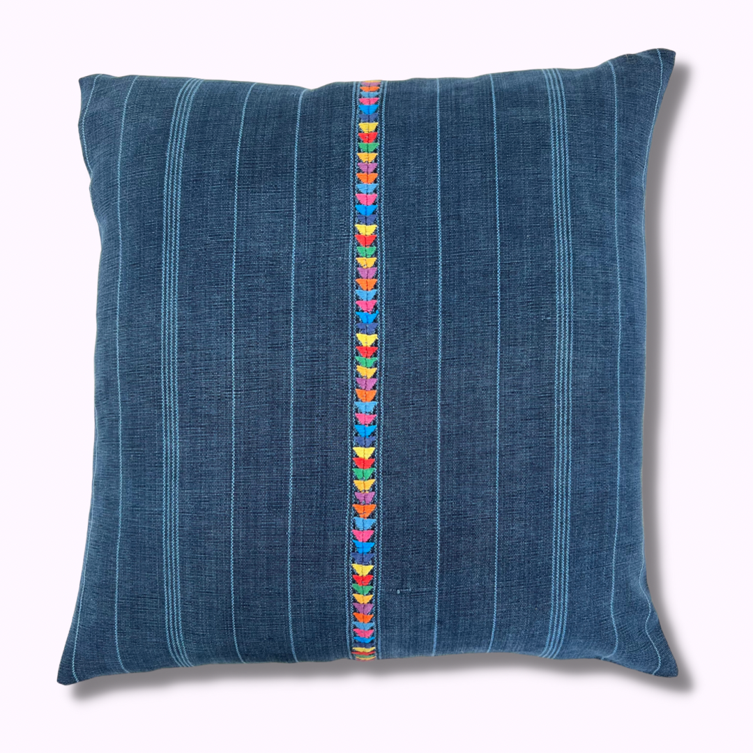 Intertwined's Indigo Corte Pillow with a hand embroidered multicolor stripe down middle.